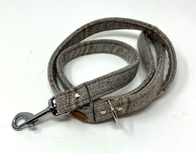 Gray dog leash with metal clip on a white background