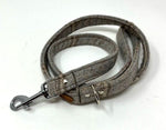 Gray dog leash with metal clip on a white background