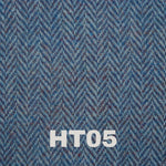 6oz Stainless Steel Hip Flask with Harris Tweed Wrap, elegantly displayed against a rustic background.