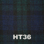 Stylish shot of the 6oz Stainless Steel Hip Flask with Harris Tweed Wrap placed on a wooden table.