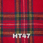 6oz Stainless Steel Hip Flask with Harris Tweed Wrap next to a glass, ideal for toasting special occasions.