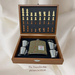 wooden box with chess pieces, harris tweed hip flask and cups and funnel