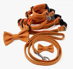 A set of orange tweed dog collar, lead, and bow tie laid out on a white background.